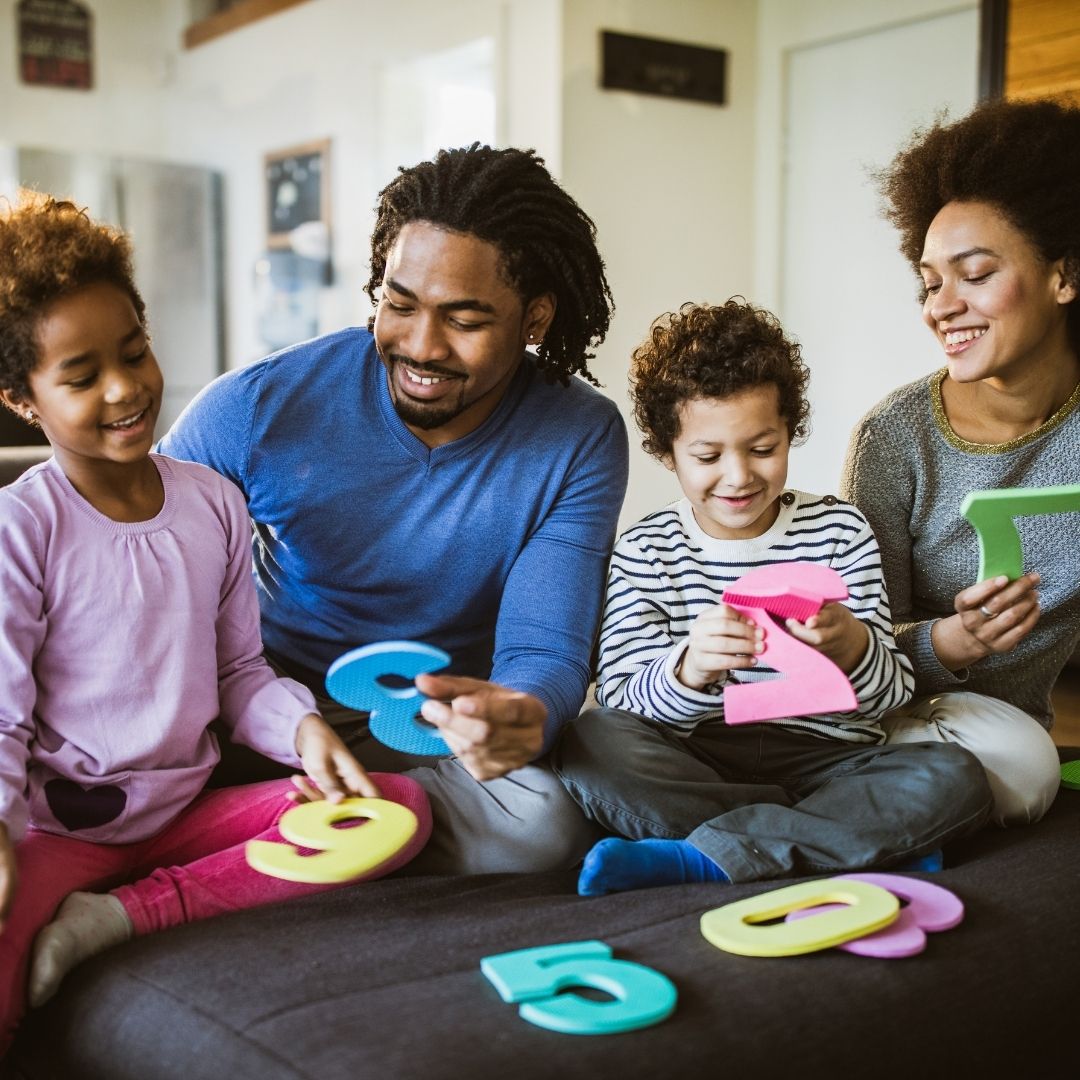family playing with foam numbers