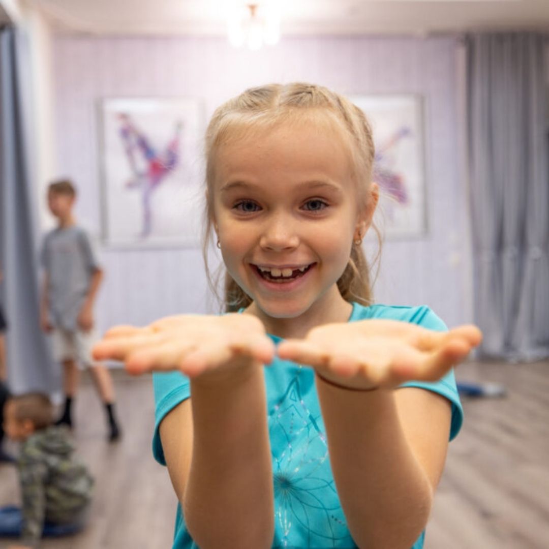 An image of a little girl with her hands out.