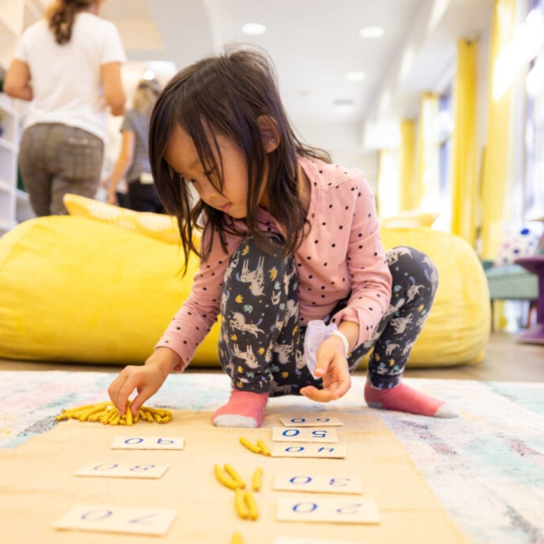 An image of a little girl working on math.