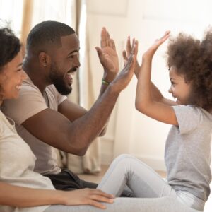 parents giving daughter a high-five